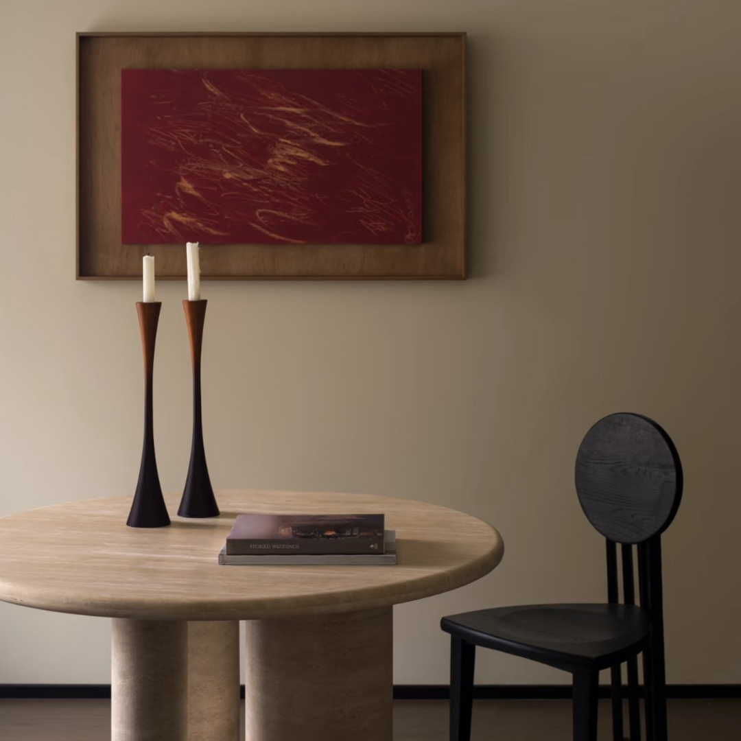 Pair of sculptural candle holders styled with natural elements in a Japandi-inspired room.