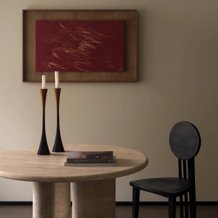 Pair of sculptural candle holders styled with natural elements in a Japandi-inspired room.