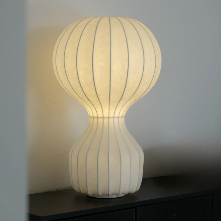 Close view of organic modern table lamp with ribbed structure in a neutral space.