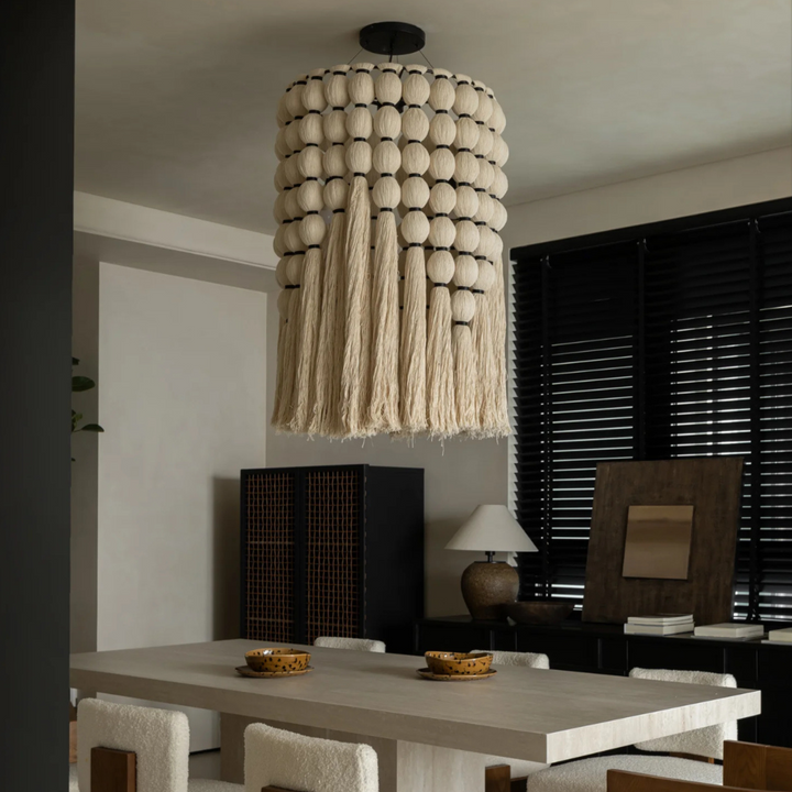 Japandi-style pendant light in soft minimalist dining room with neutral tones.