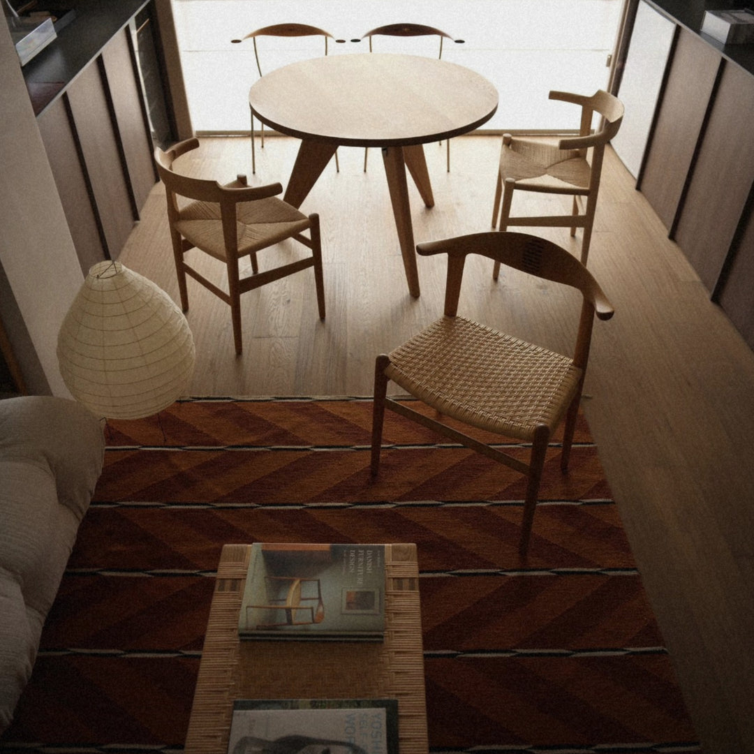 japanese washi paper floor lamp illuminating a cozy living room with wooden furniture and soft neutral tones.