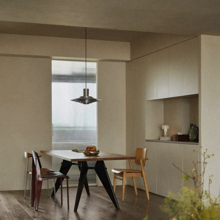 kitchen pendant lamp hanging above a table in a soft neutral space.