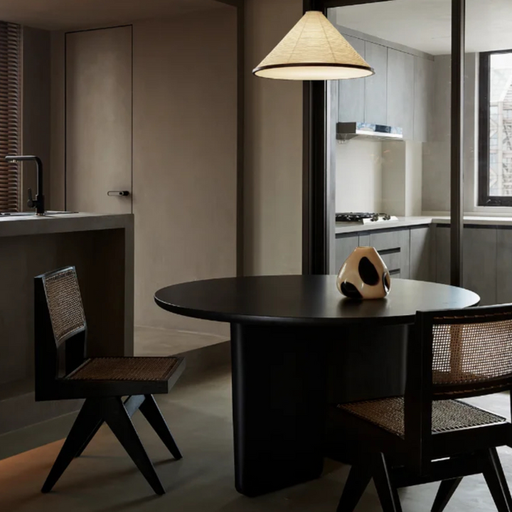 Organic textured pendant lamp illuminating a sleek, modern kitchen setup.