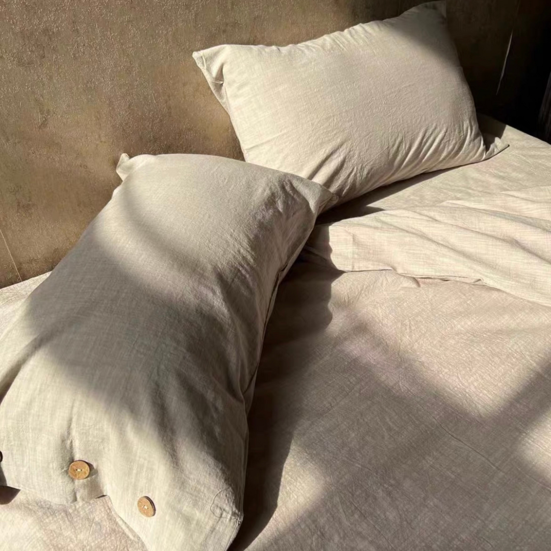 Linen bed sheets bathed in natural light, highlighting their luxurious softness