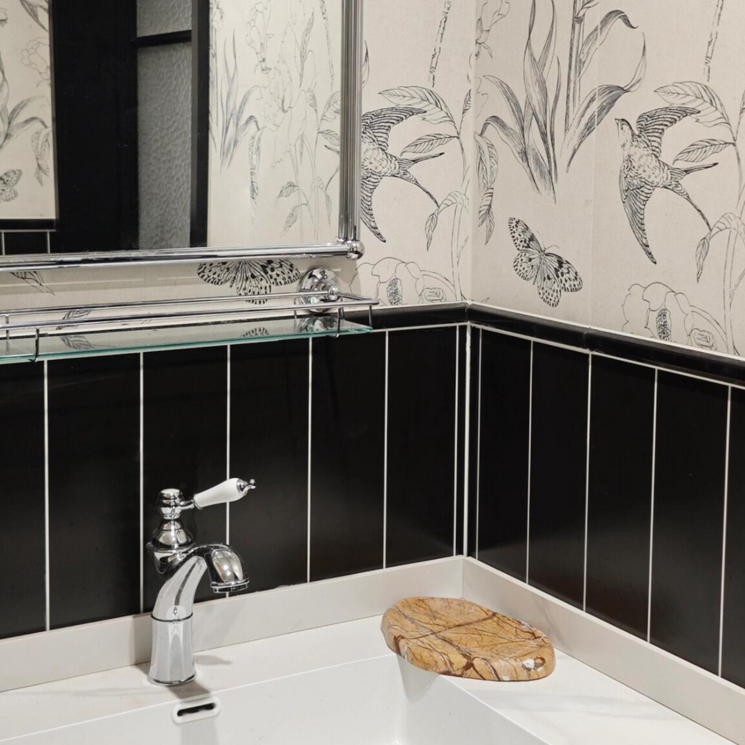 Decorative marble tray styled in a black-and-white bathroom, adding a touch of organic charm.