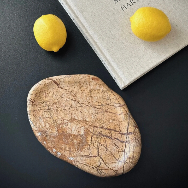 Natural marble tray with subtle veining, paired with lemons for a vibrant, decorative display.