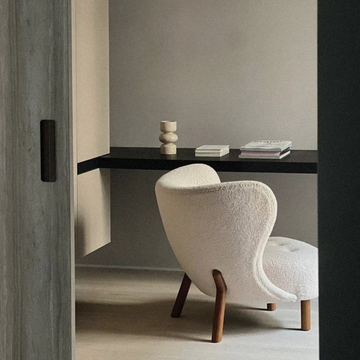 marble decorative vase styled on a floating shelf in a calm minimalist interior.