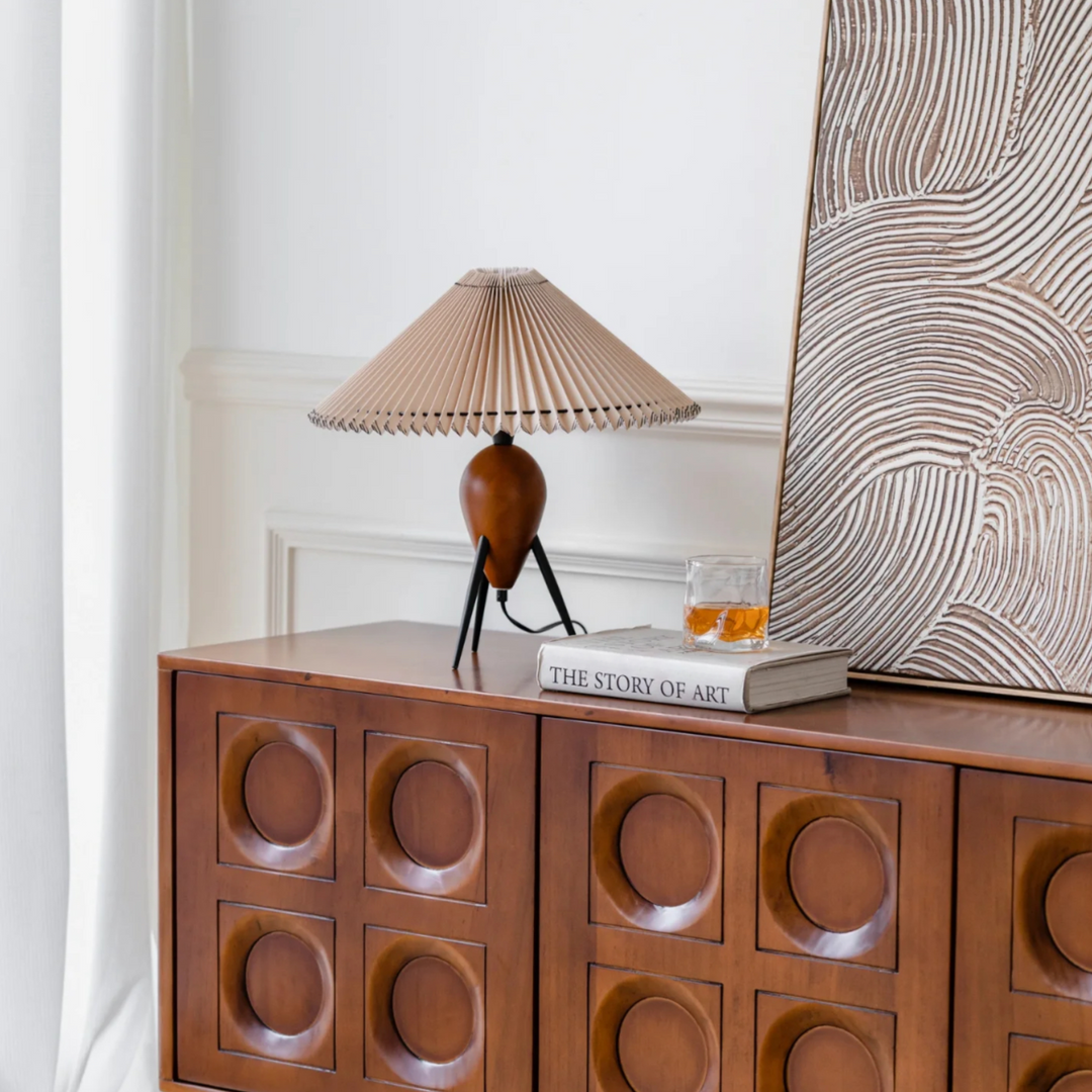 Mid-century lamp on a brown dresser featuring a stylish home interior.