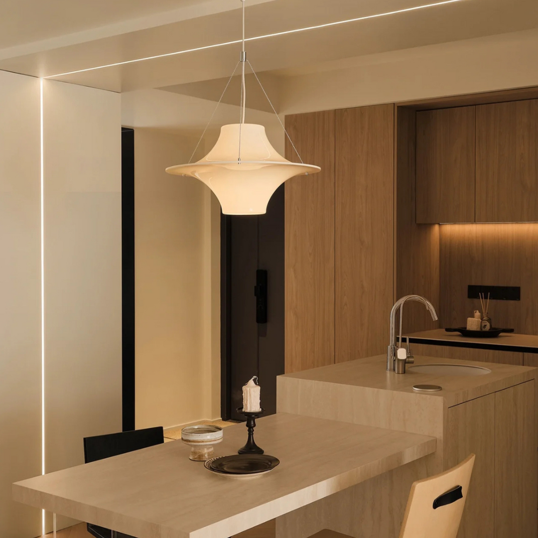 Mid-century modern inspired pendant light hanging in a contemporary kitchen setting, adding a touch of nostalgia.