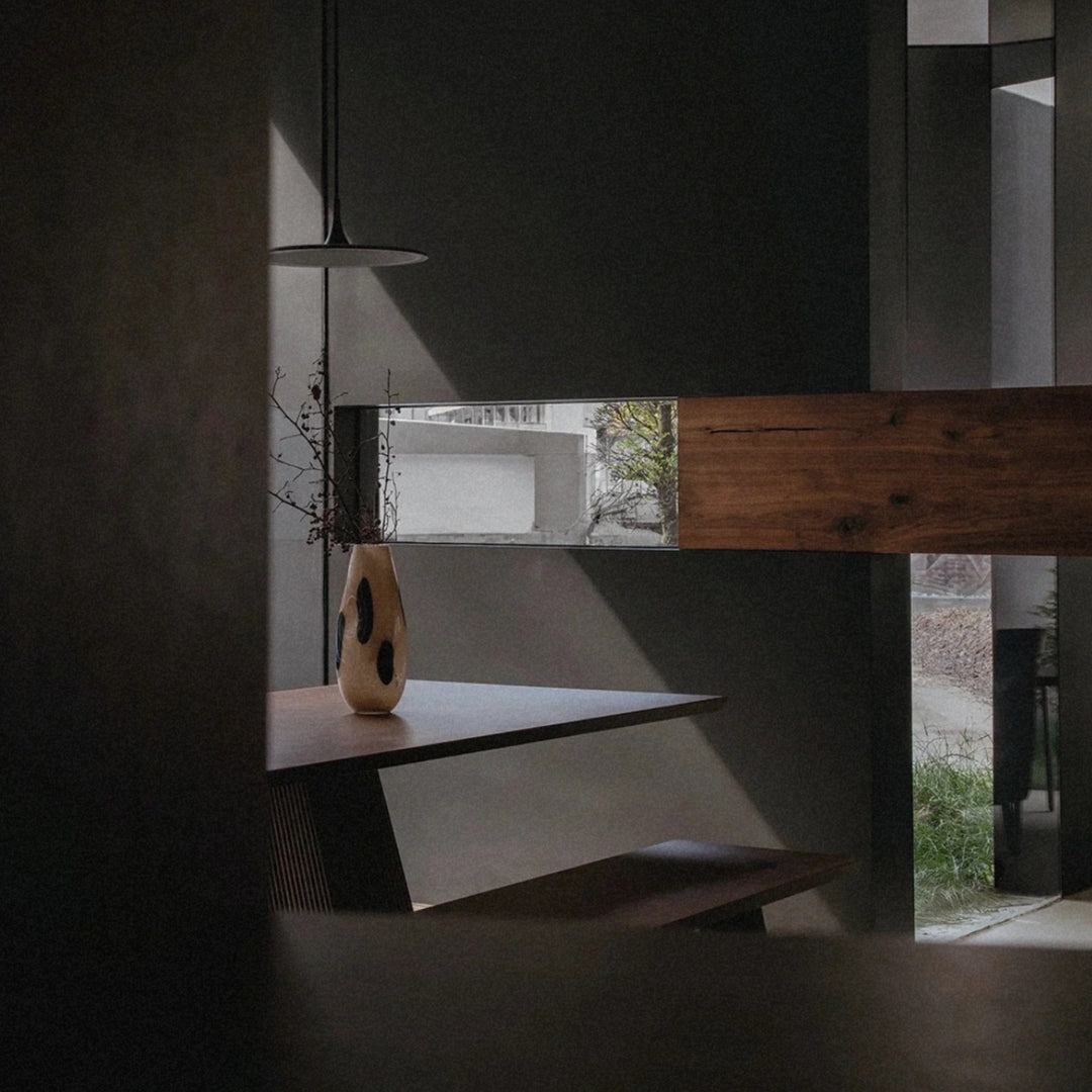 glass vase set on a floating shelf beside a window bringing a subtle decorative touch to the room.
