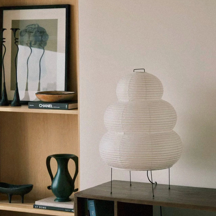 minimal paper floor lamp standing near a sofa in a bright modern interior.