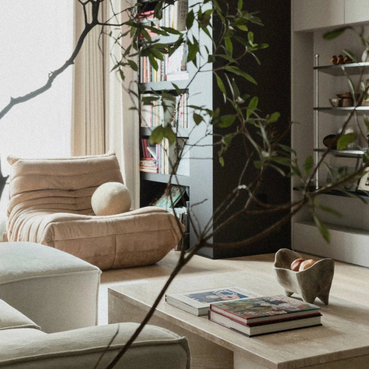 minimal wooden fruit bowl displayed on a coffee table in a calm contemporary interior.