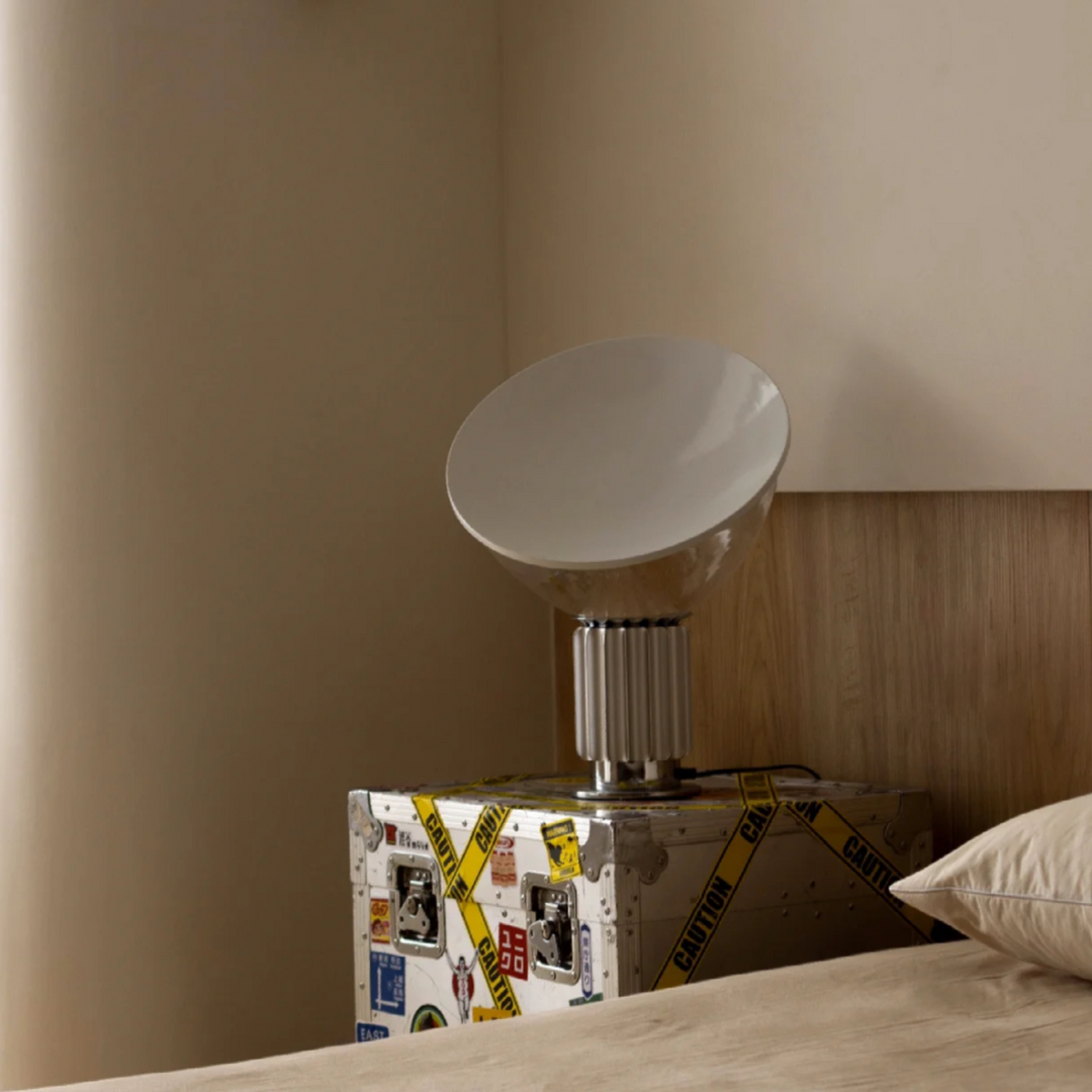 Minimalist bedroom with lamp on luggage-style side table