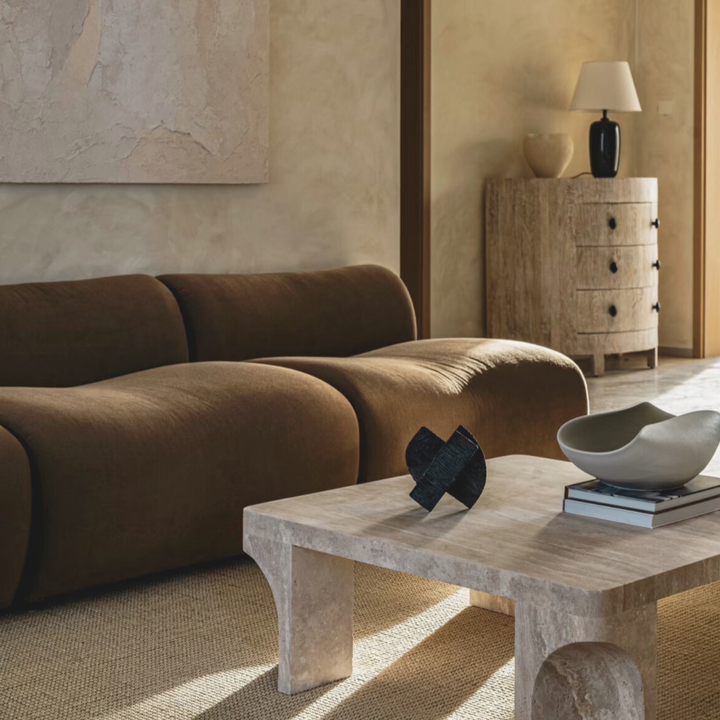 Minimalist coffee table topped with a handmade ceramic bowl, styled in a modern living space.