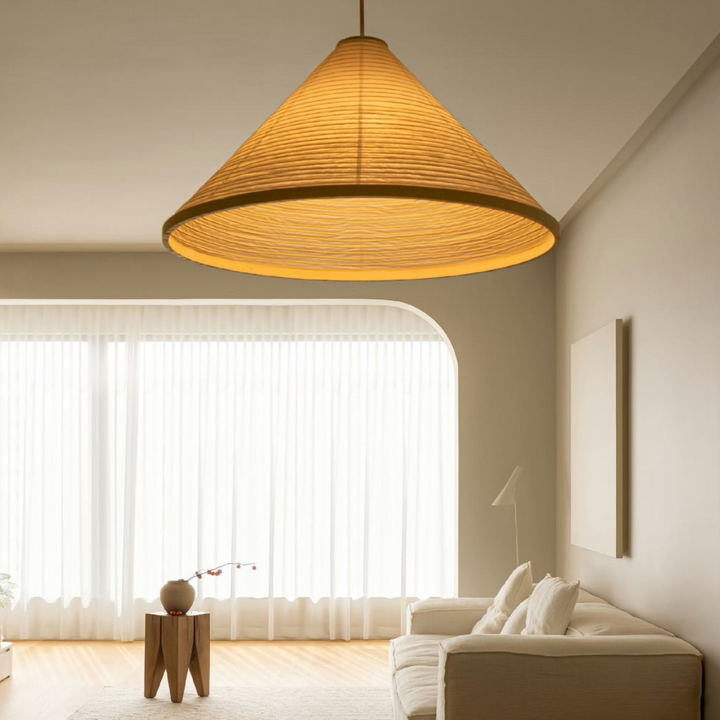 Minimalist cotton paper pendant lamp softly glowing in a modern living room with neutral tones.