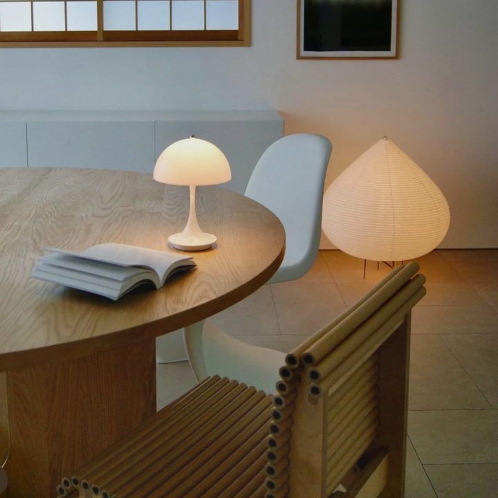 A minimalist dining room setup featuring a cordless mushroom lamp, adding elegance and simplicity to the space.