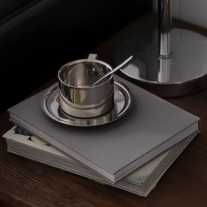 Minimalist espresso cup displayed on a book and modern table, reflecting a chic urban lifestyle.