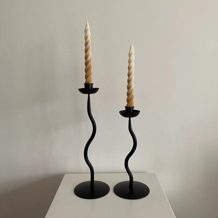 Minimalist home decor with two elegant candle holders on a white surface, showcasing their modern design.