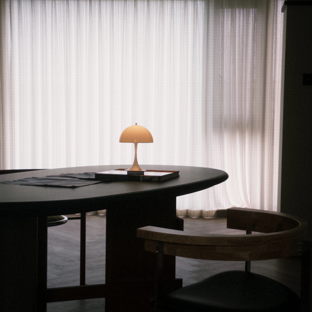 A minimalist living space accented by a cordless mushroom lamp, providing subtle yet impactful illumination.