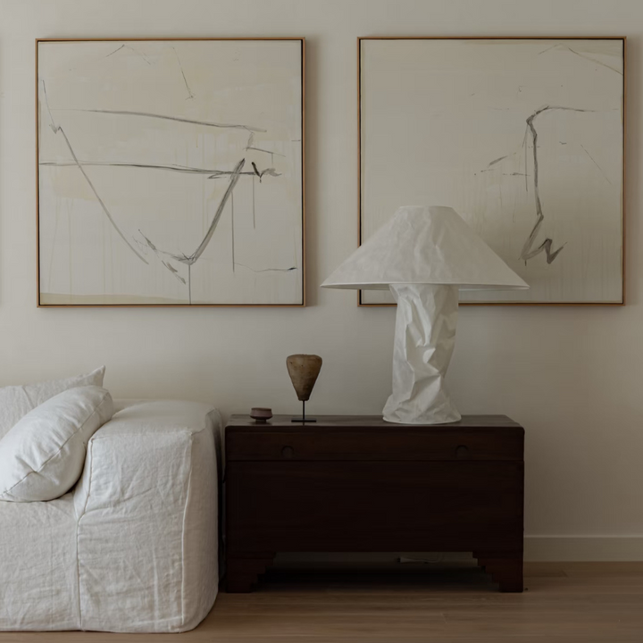 Minimalist table lamp styled in soft, modern white interior.