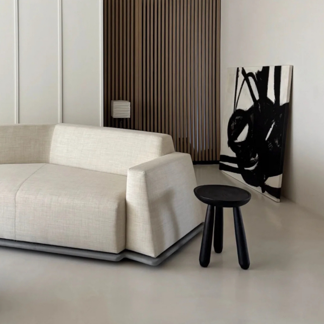 Brown wooden side table styled in a neutral living room with clean lines and modern decor.