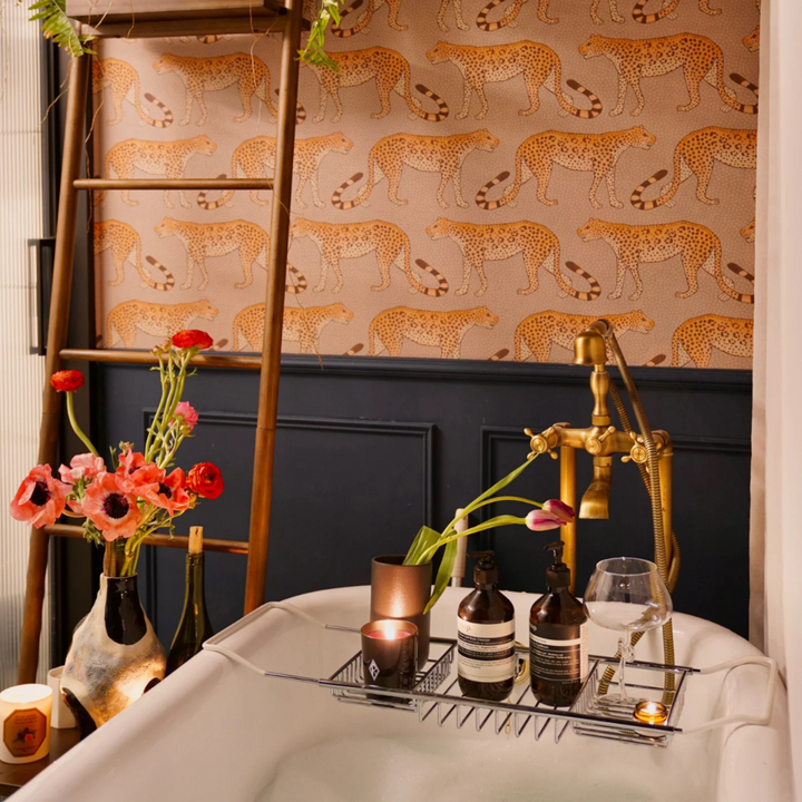 A stylish bathroom scene featuring a modern wine glass, flowers, and bath accessories, creating an elegant atmosphere.