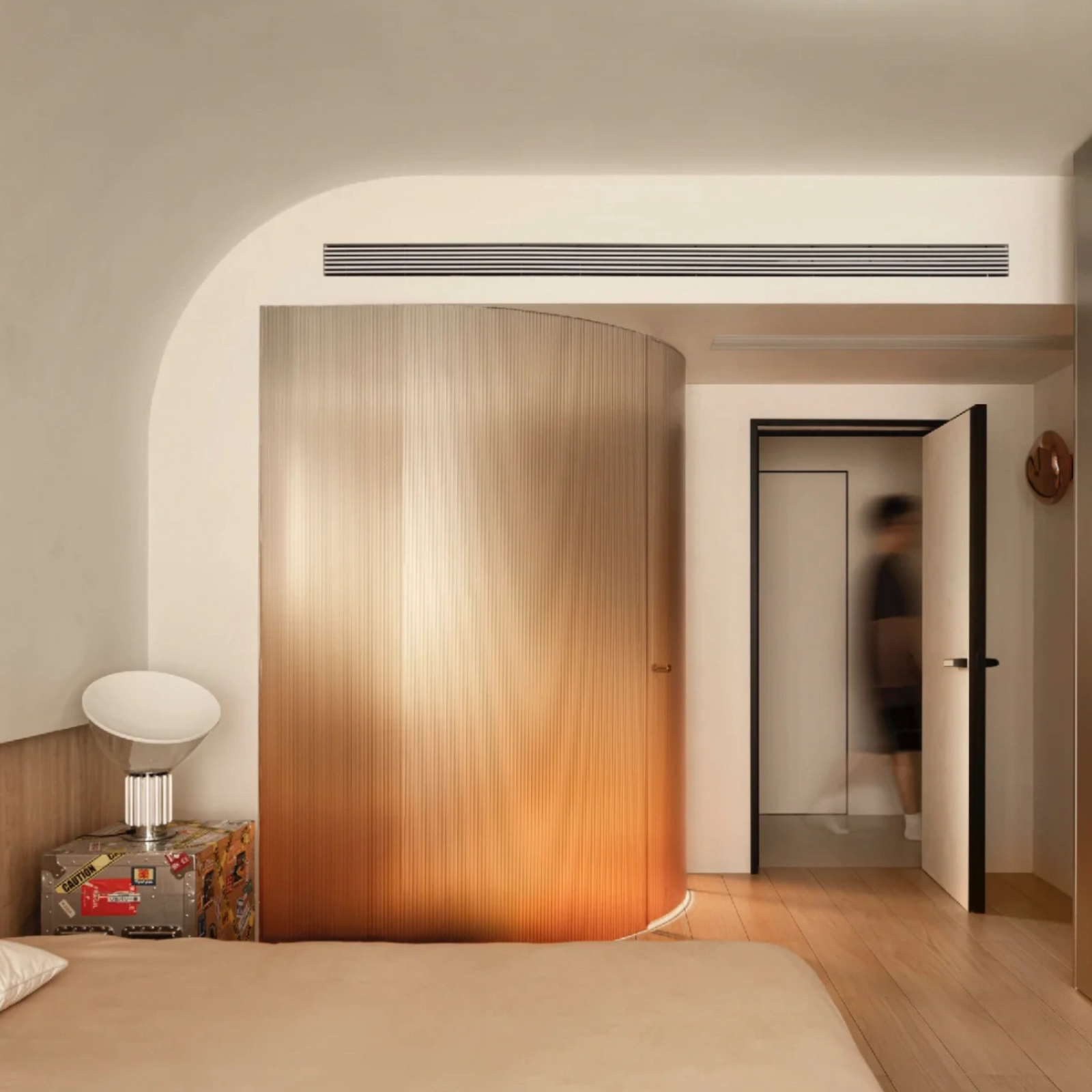 Modern bedroom with soft glow lamp and curved walls