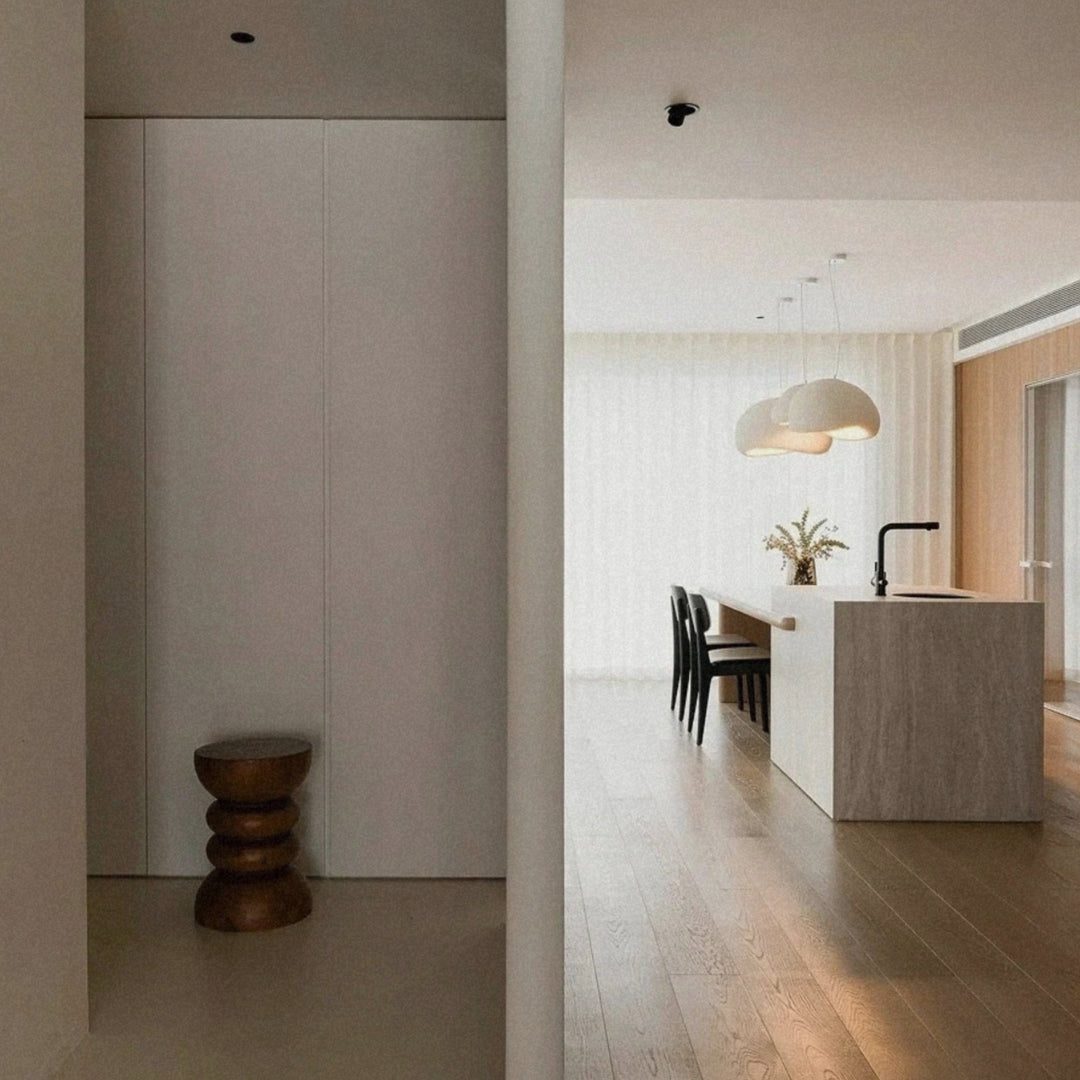 ceiling pendant light visible through an open interior with wood and neutral tones.