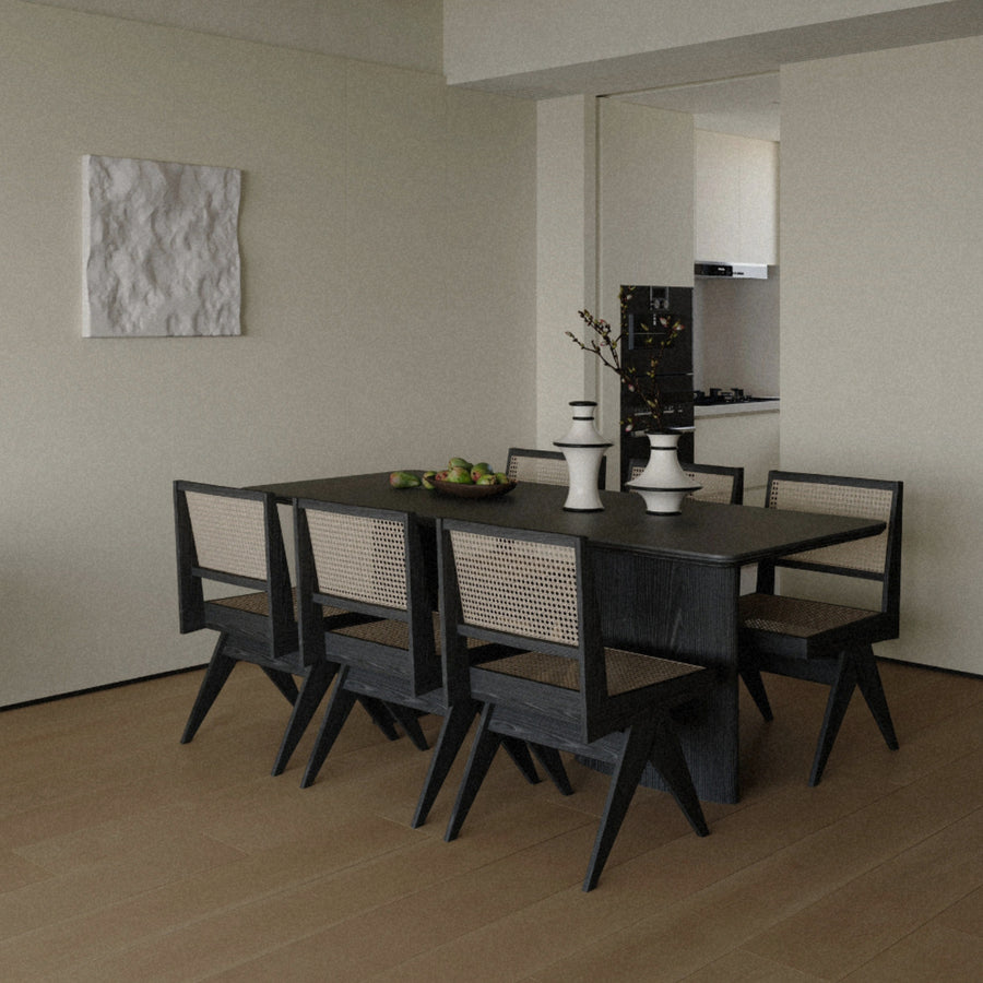 modern ceramic decorative vases styled as a dining table centerpiece in a calm organic modern dining room with neutral tones.