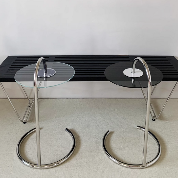 Modern glass coffee table with a sleek, minimalist design, featuring a chrome base. Perfect for contemporary living rooms and stylish interiors.