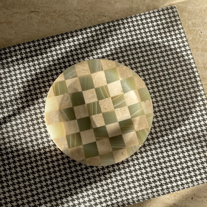 Modern checkerboard tray crafted from jade marble and travertine, displayed on a houndstooth pattern cloth.