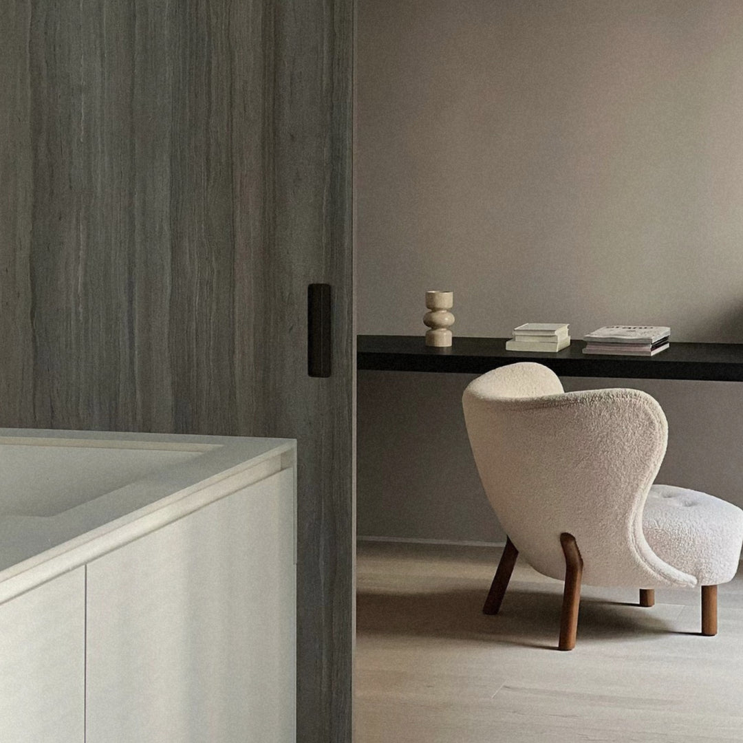 modern marble vase displayed on a black shelf creating subtle decor in a contemporary room.