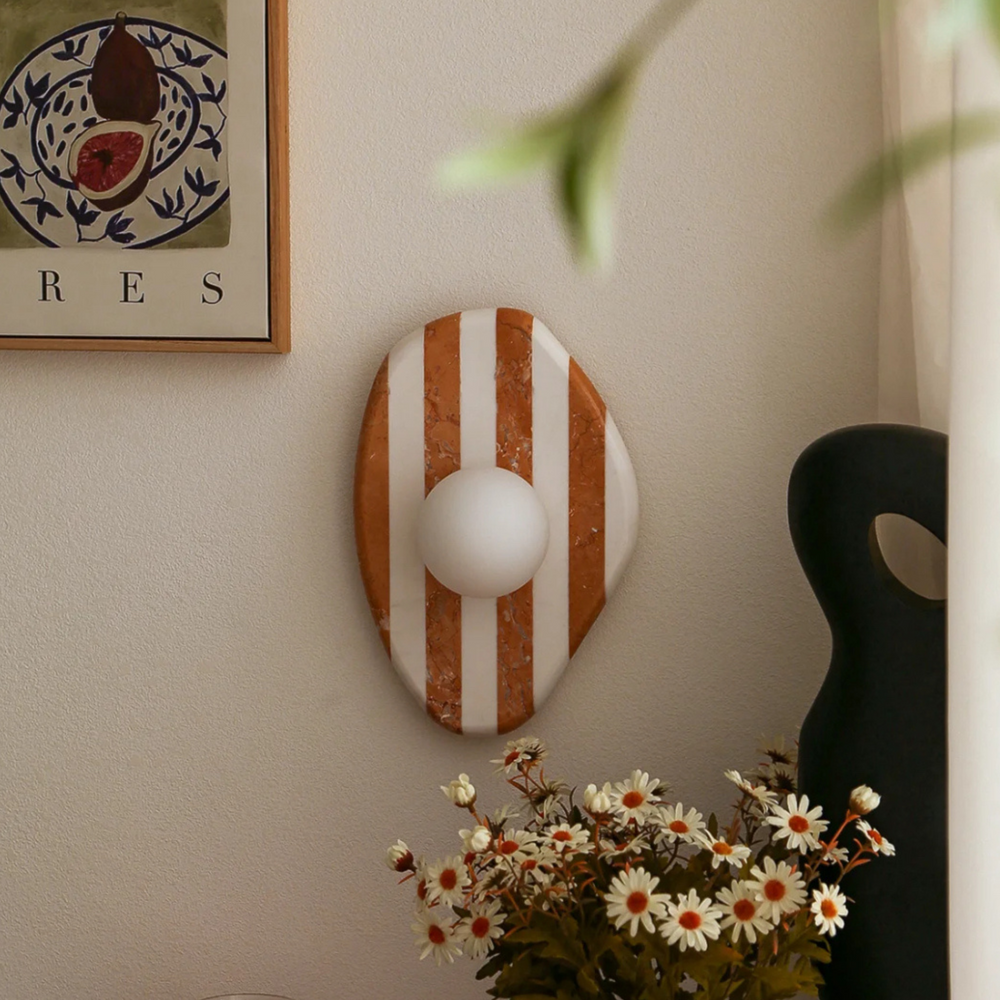 Modern wall sconce featuring a marble base with brown and white stripes, ideal for contemporary interiors.