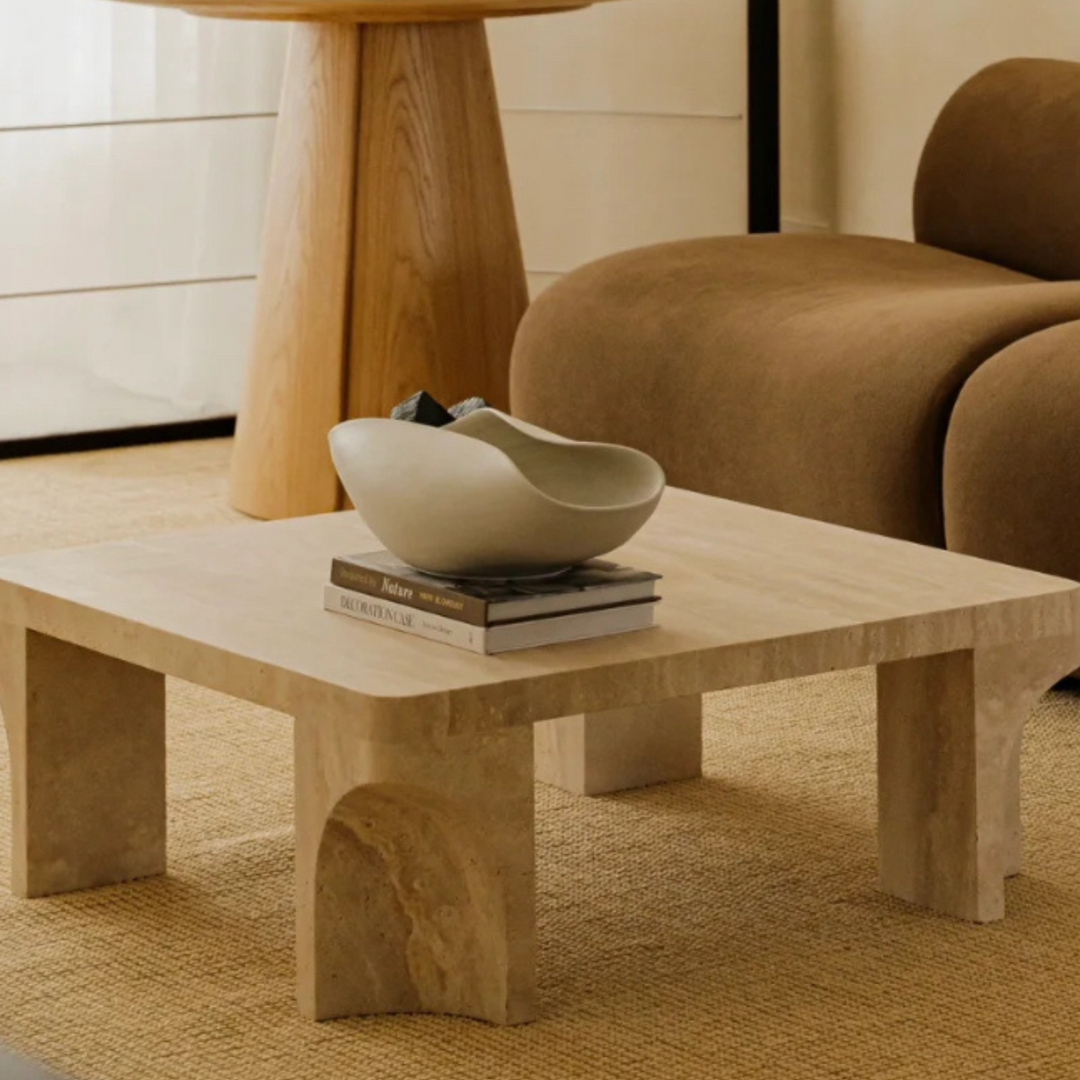 Modern neutral living room with a striking ceramic bowl centerpiece and earthy tones throughout.