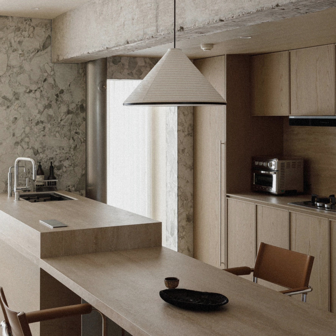 modern pendant light used above a kitchen counter in a warm interior.