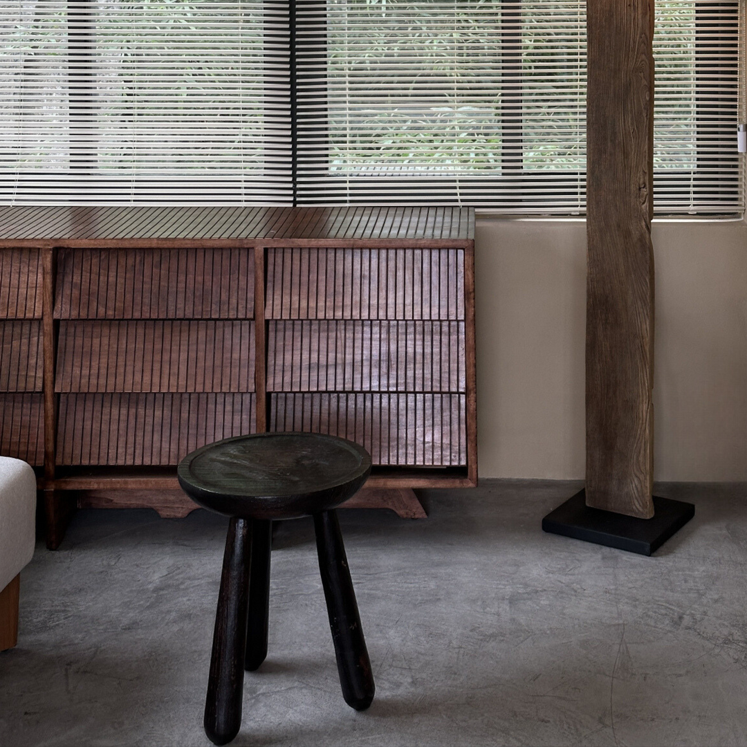 Modern rustic side table styled with minimal decor, placed next to a rattan cabinet.