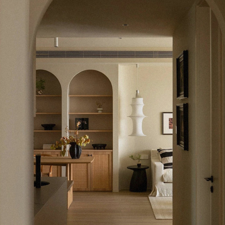 modern sculptural pendant light illuminating an open plan living space.