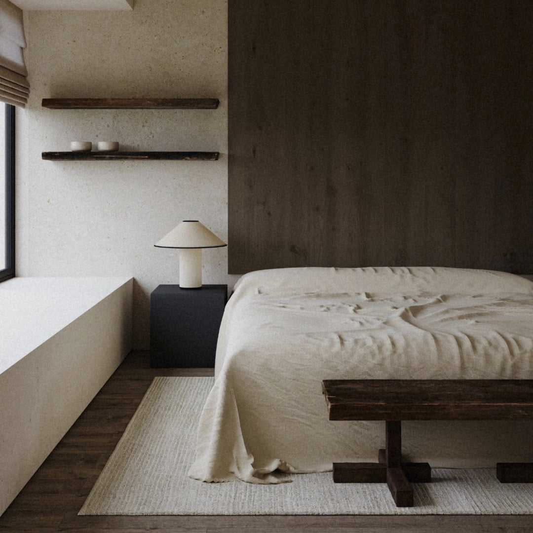 modern table lamp styled beside a bed with warm wood accents.