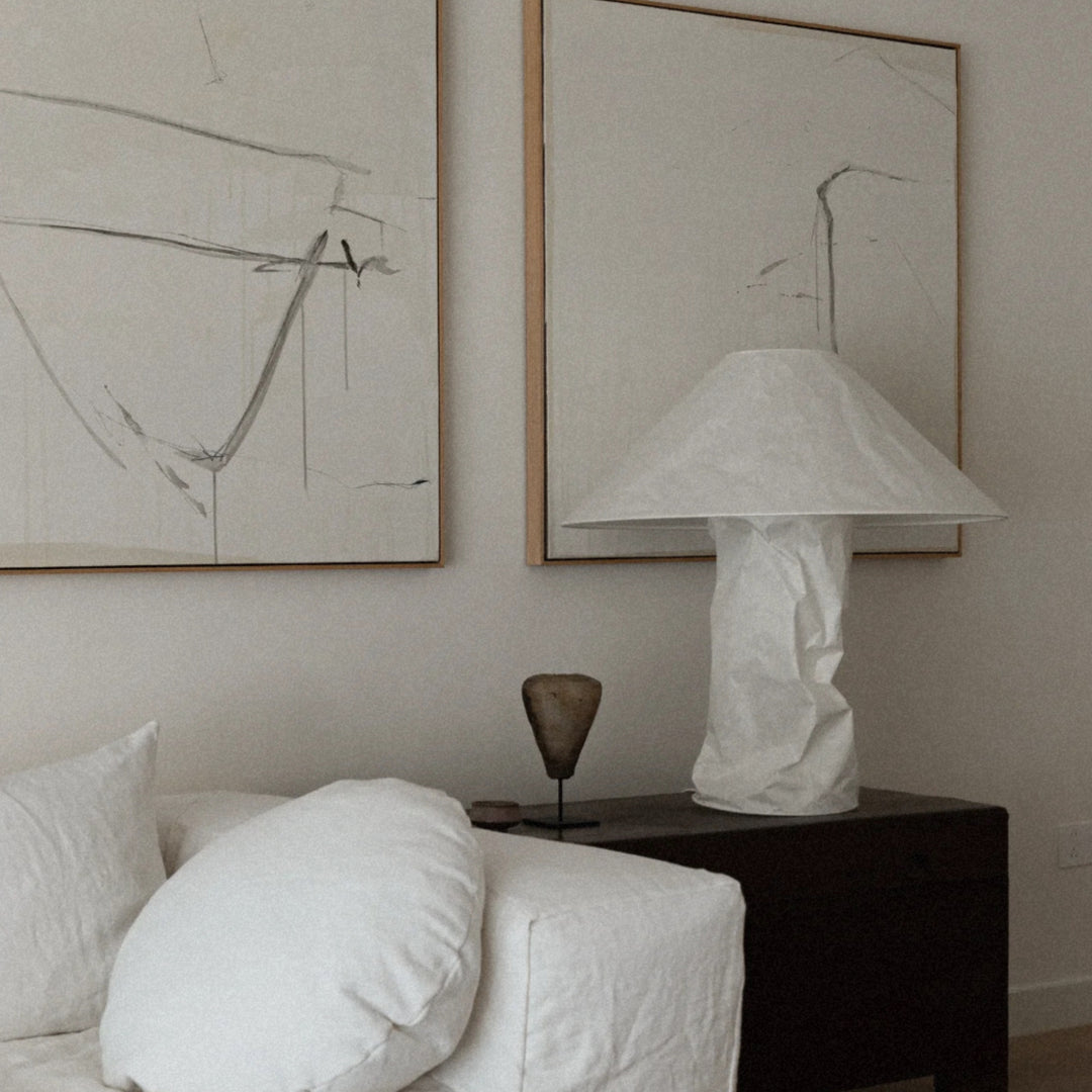 modern table lamp positioned on a side table next to soft seating.