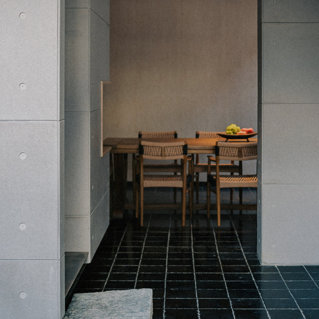 modern wood bowl used as a table accent in a dining area.