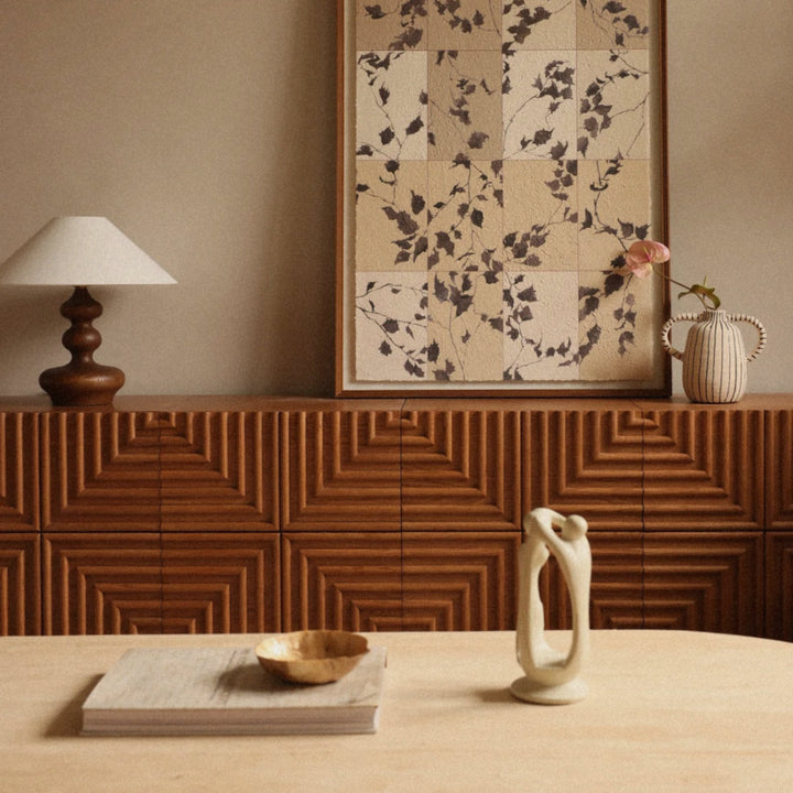 modern wood table lamp styled behind a dining table in a warm interior.