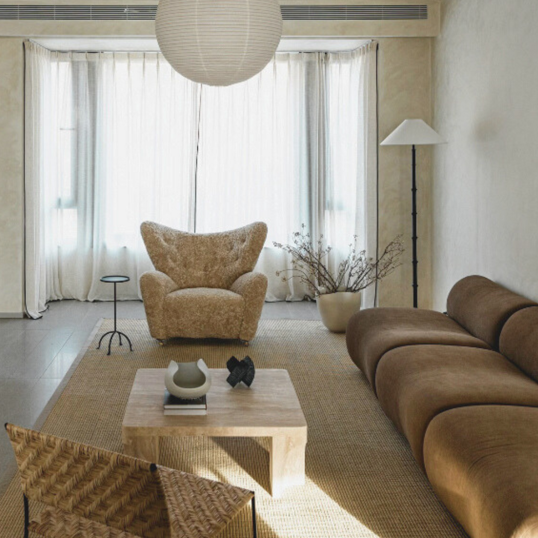 Natural ceramic bowl paired with minimalist interior design featuring plush brown sofas and a warm neutral palette.