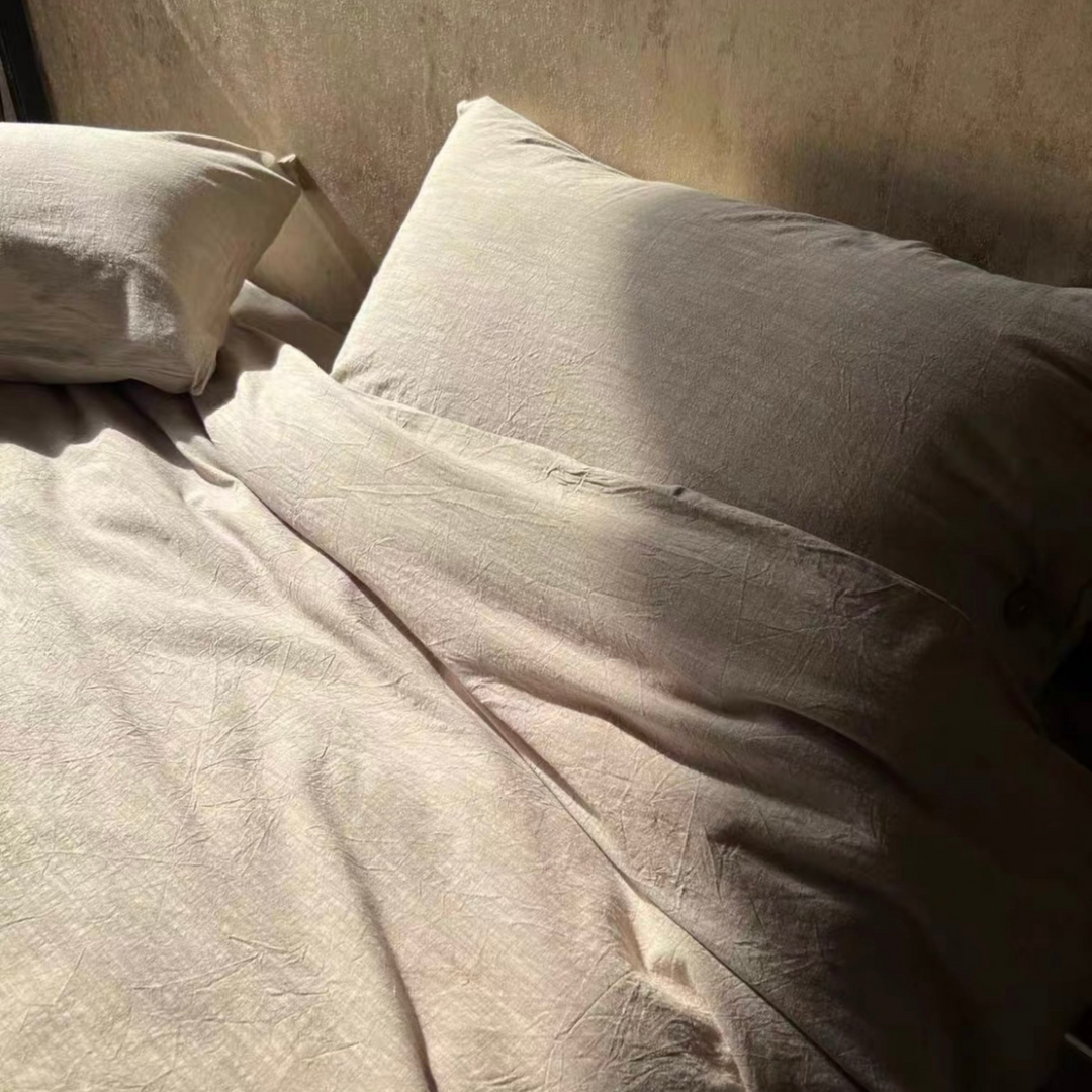 Natural linen bedding set on bed, showcasing soft and cozy texture