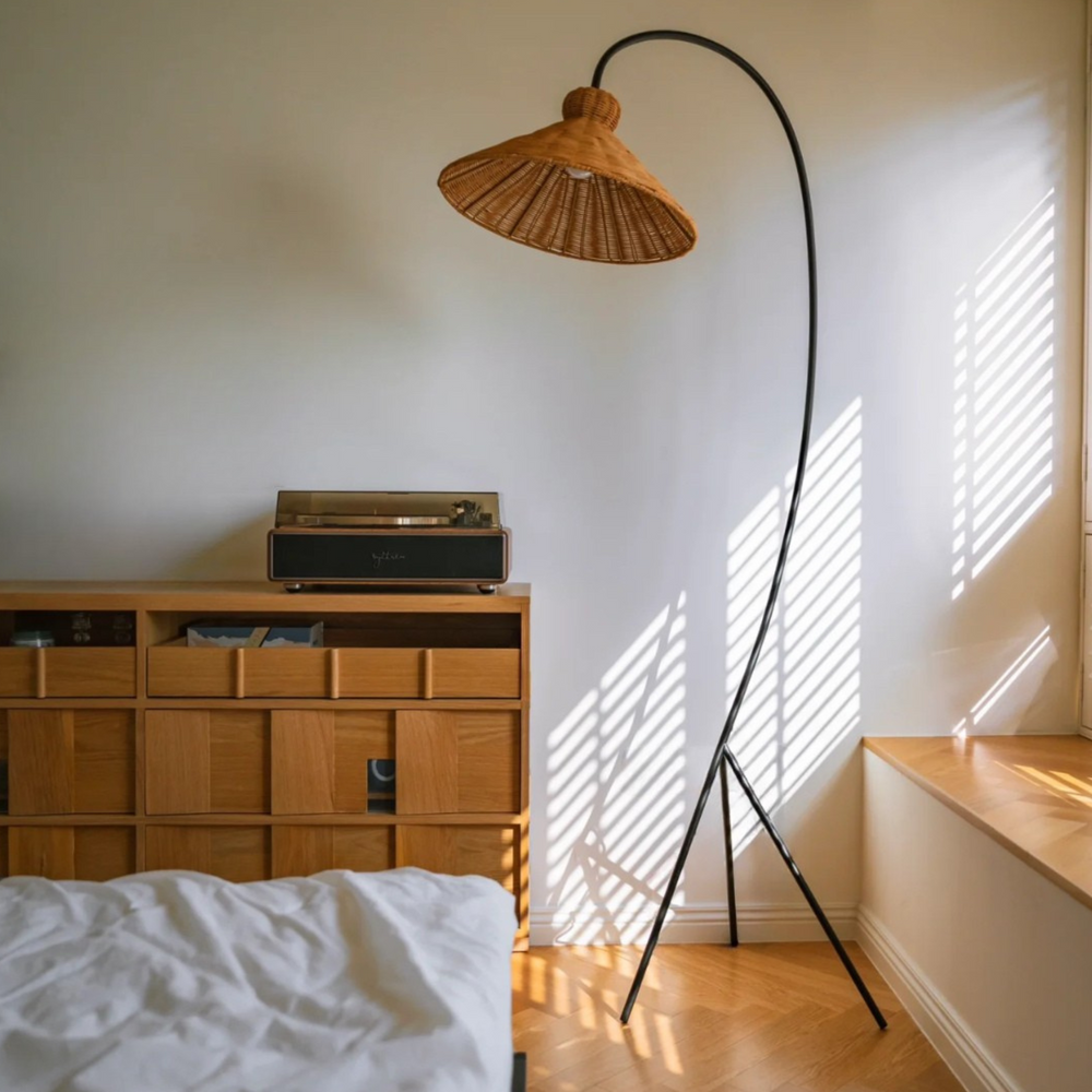 Sunlit room with a natural rattan floor lamp, creating a cozy and inviting ambiance with soft lighting.