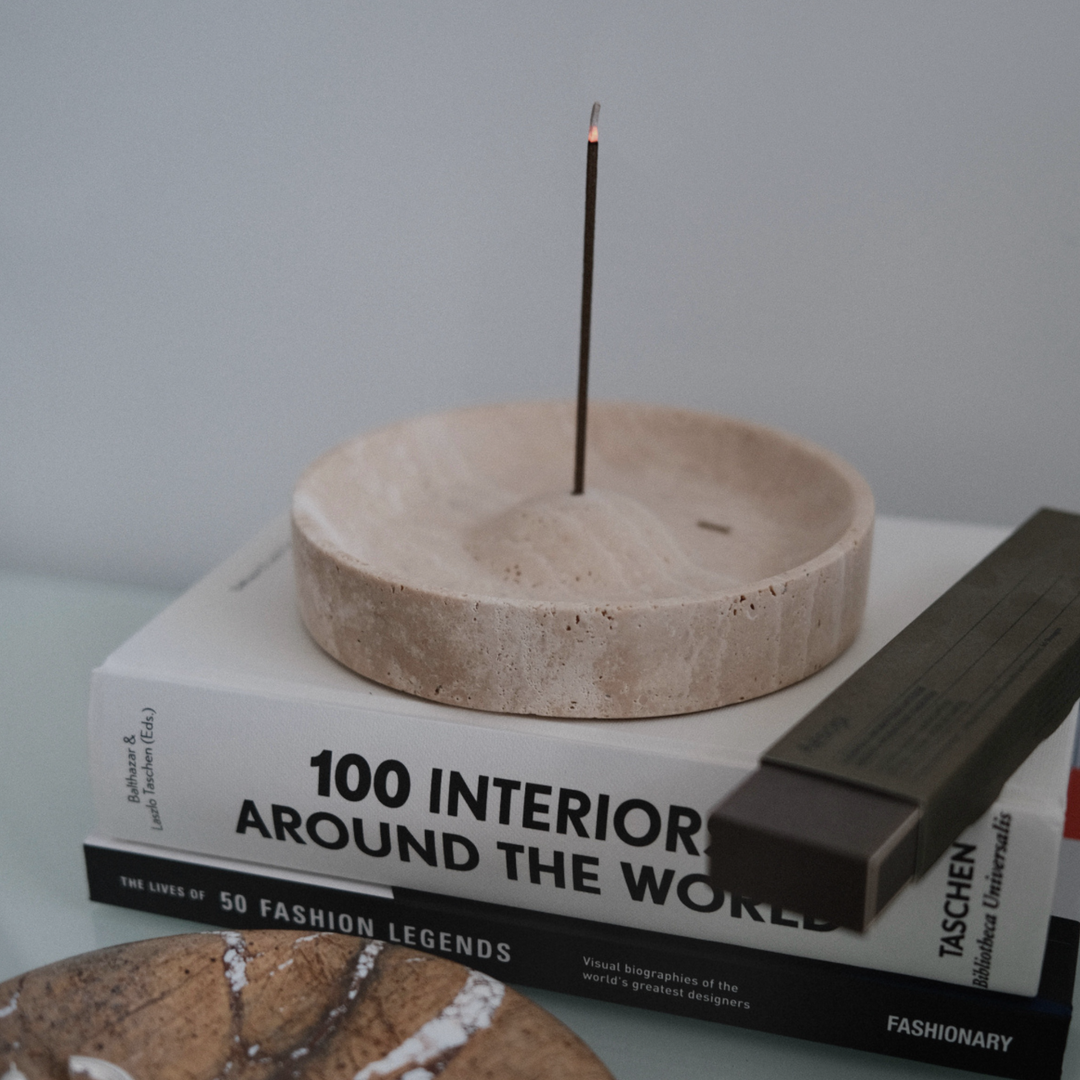 Natural travertine incense holder placed on a design book, perfect for modern minimalist decor.