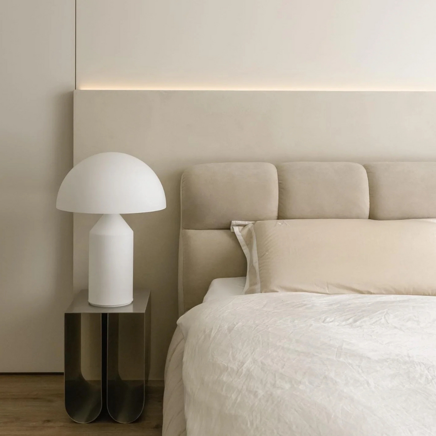 White table lamp in a neutral bedroom, complementing the serene decor with soft, calming light for a peaceful retreat.