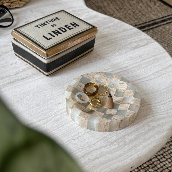 Neutral-toned checkerboard tray made from jade marble and travertine, bathed in natural sunlight.