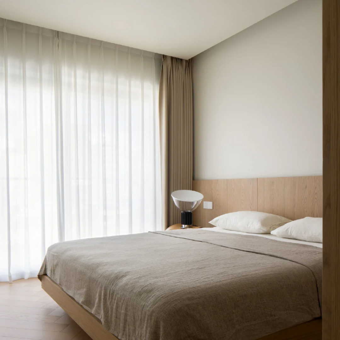 Neutral-toned bedroom with modern table lamp