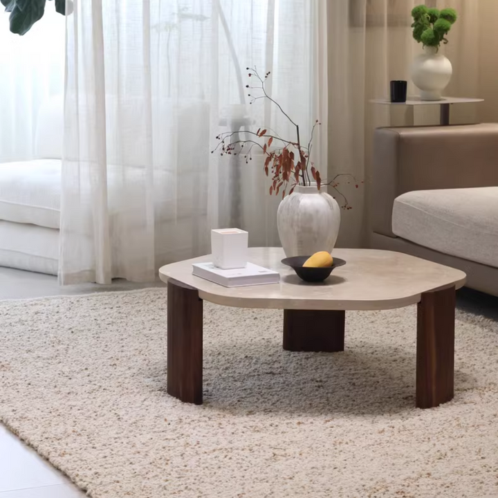 Neutral tones coffee table with travertine top and oak legs in a cozy living room