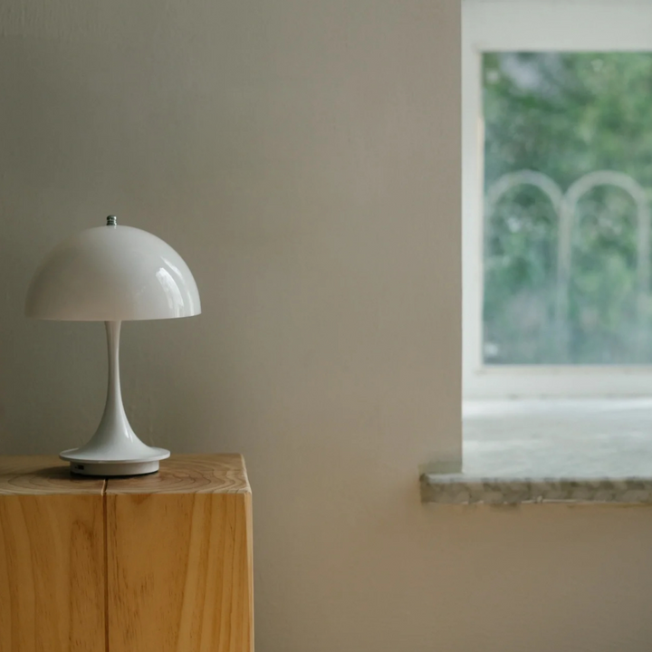 Nordic-style bedroom featuring a portable mushroom lamp, enhancing the space with soft light and clean lines.